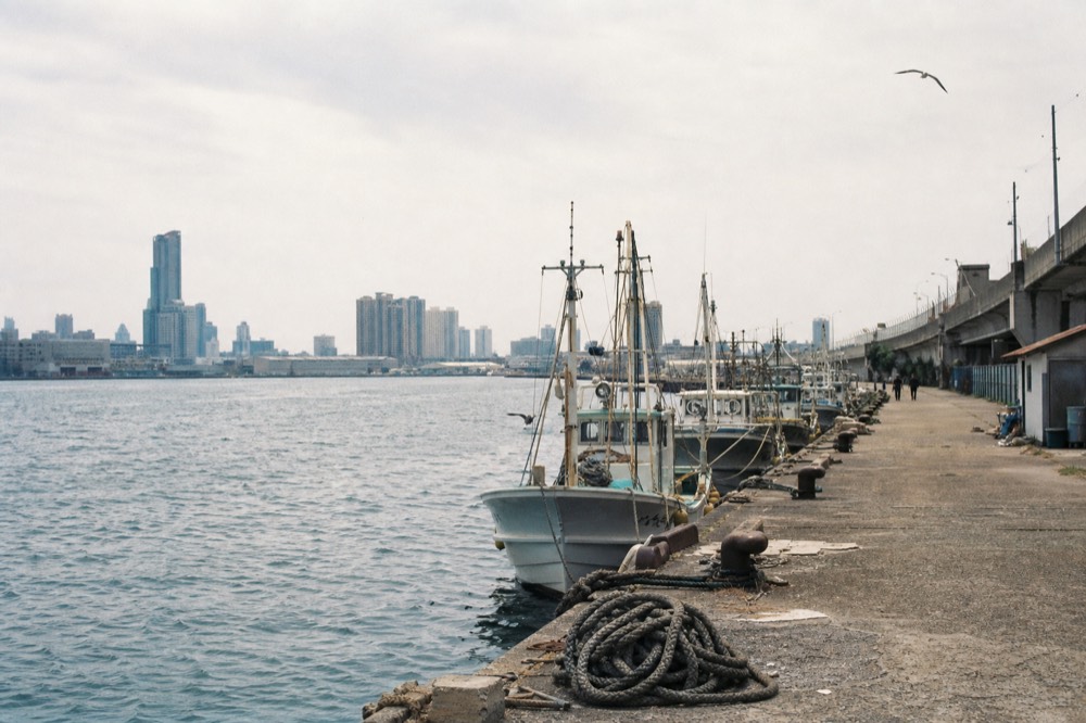 Wide view of the Osaka Bay harbour at Tempozan with moored boats and open walkways along the water