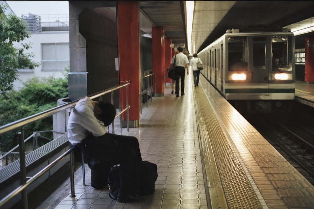 A subway platform on the Osaka Metro Chuo Line with a train arriving