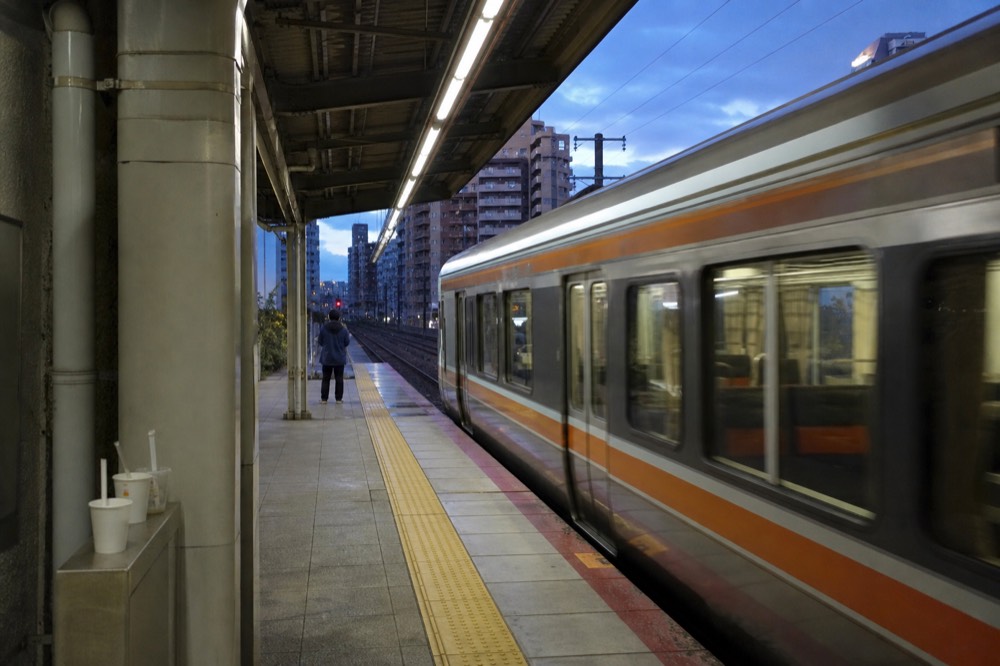 Subway platform on the Osaka Metro Chuo Line with a train arriving