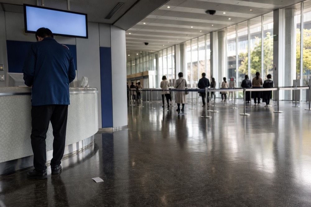 Ticket counters and electronic price board inside a bright entrance hall