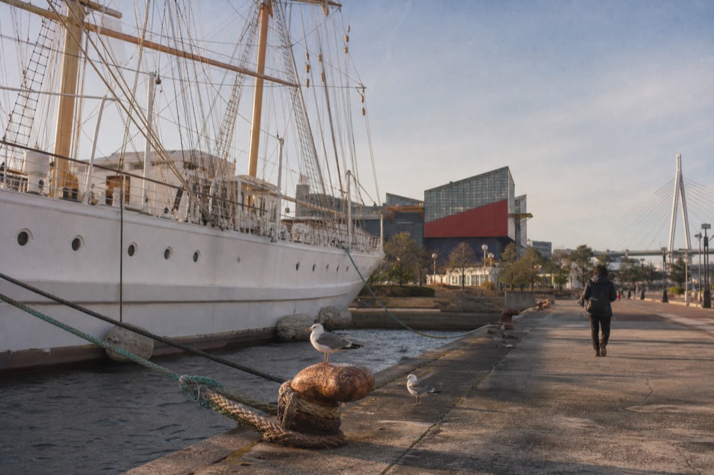 Replica sailing ship moored at a harbour wharf beside the aquarium
