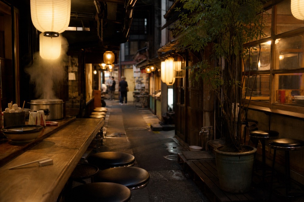 Retro market alley with illuminated food stall signs and lanterns